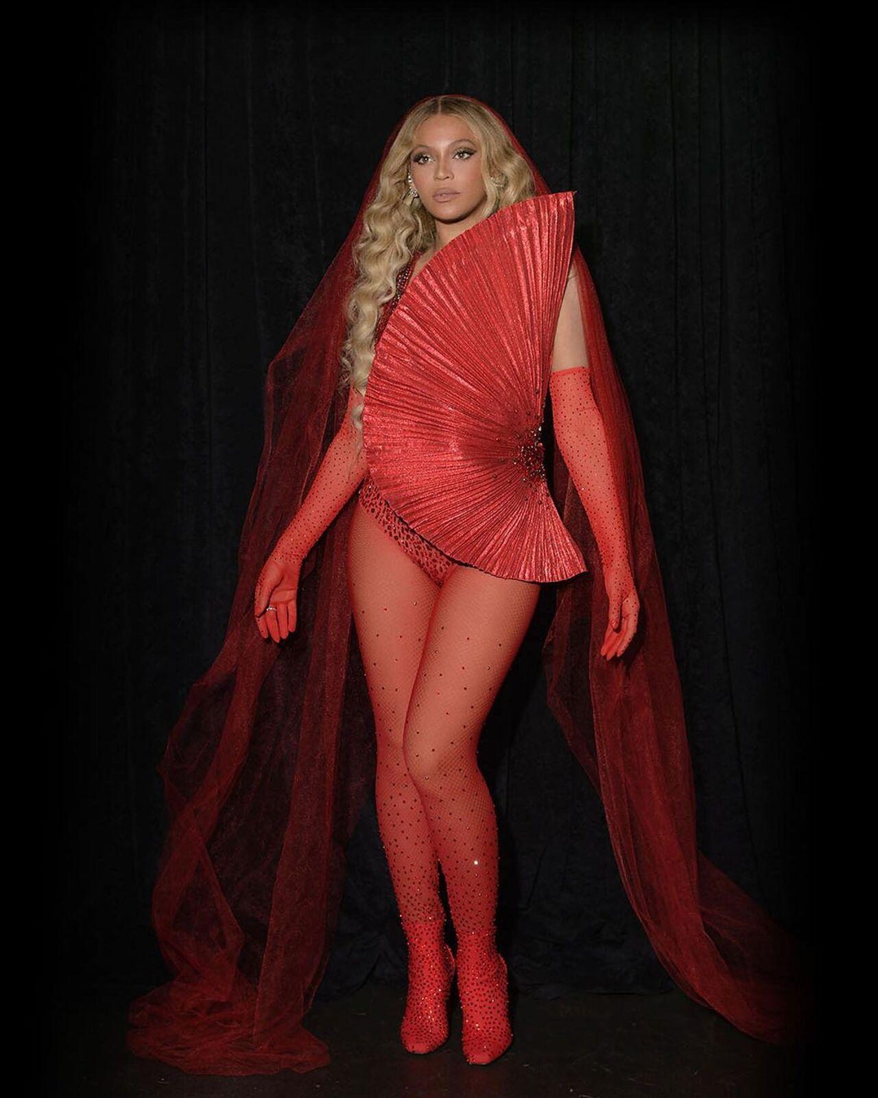 Beyonce's Rennaisance World Tour started in Stockholm – with a mighty 57 stadium dates around the world to follow – before heading on to Brussels, London, Barcelona, Marseille and Amsterdam. She is definitely making a style statement with this flowing red lacy dress - complete with a cape and gigantic fan pinned to the outfit