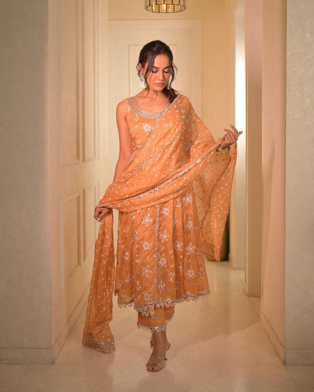 In this picture, Surbhi Jyoti donned an elegant orange embroidered suit with a matching dupatta