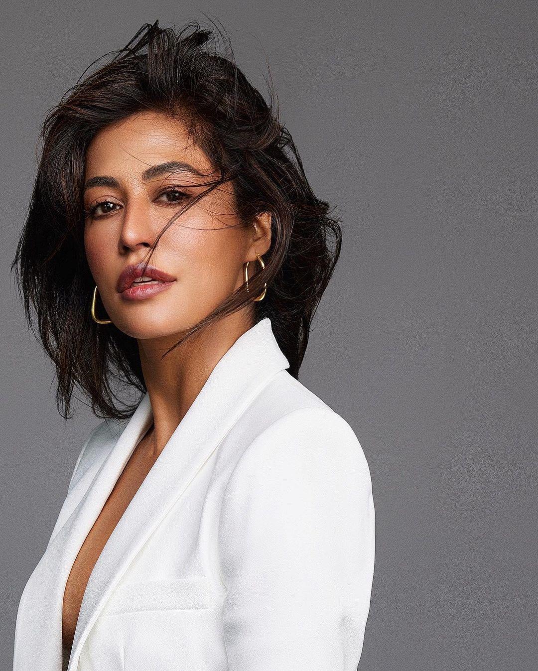 Accessorized with just the right pieces, like simple earrings, Chitrangadha pulls off the white power suit look flawlessly.
