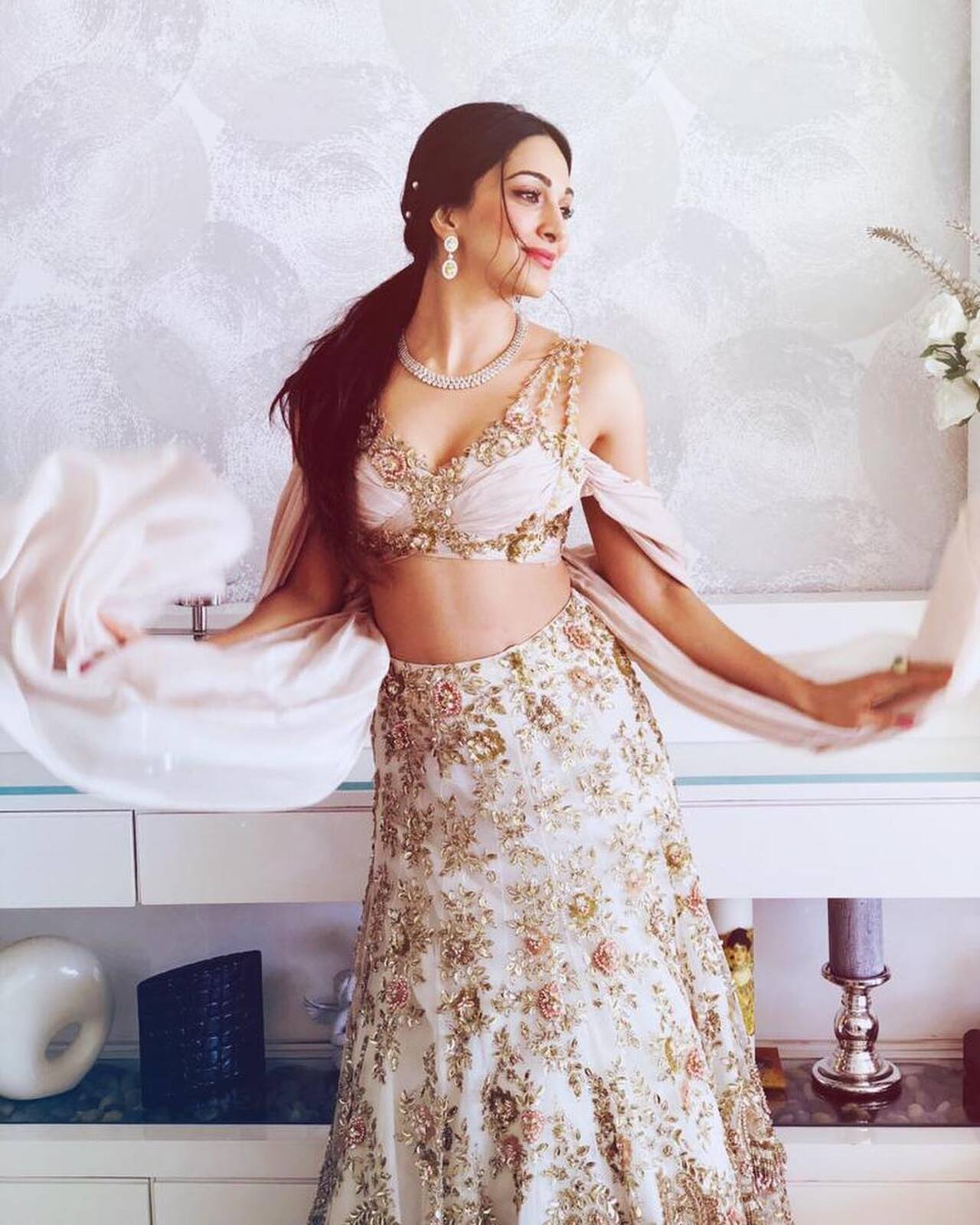 Kiara Advani
The actress radiated elegance in her shimmering peach-pink lehenga adorned with golden floral motifs. She paired her ensemble with impeccably chosen stone-studded necklaces and earrings. Kiara's dazzling smile was the perfect finishing touch to her ensemble!