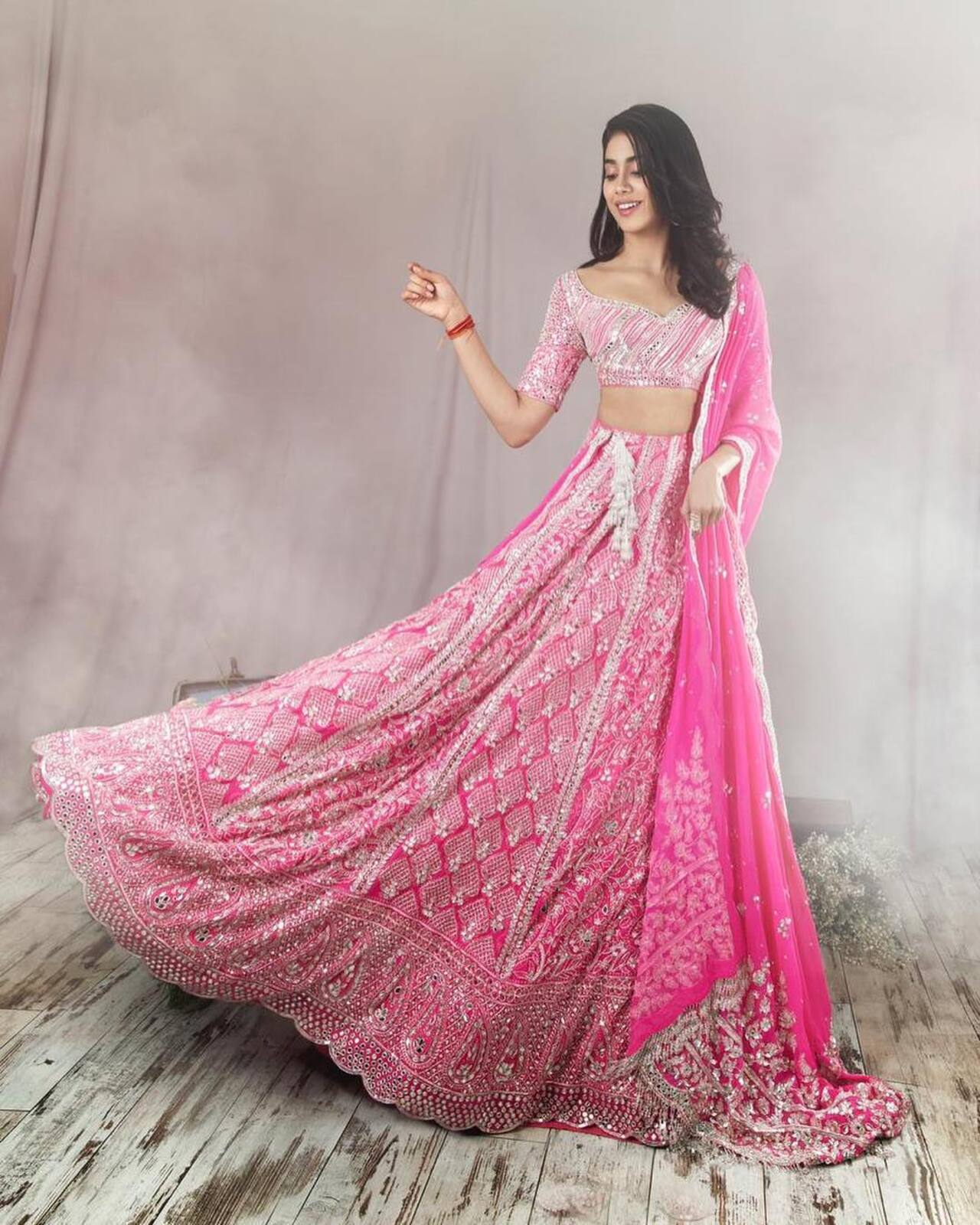 Janhvi Kapoor
For Akash Ambani and Shloka Mehta’s reception, the star wore a fuschia pink Manish Malhotra lehenga. The ensemble had silver thread embroidery with paisley and kite motifs. The blouse had a curvy neckline and mirror embellishments. Janhvi Kapoor completed the look with a matching dupatta, diamond earrings, and delicate finger rings
