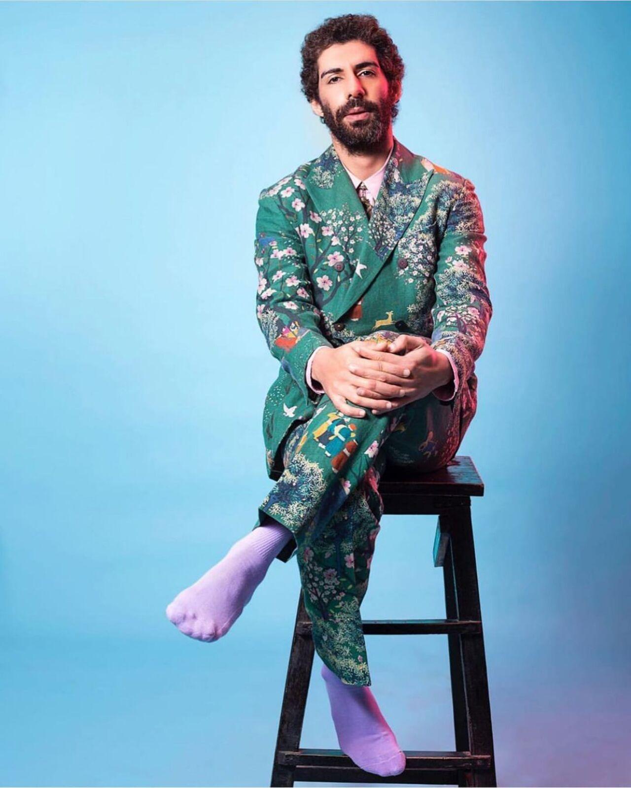 The 'Made in Heaven' actor often makes androgynous sartorial choices and flaunts singular cuts, styles and prints in his outfits - such as this wrap-around sage green suit with a flamboyant floral print