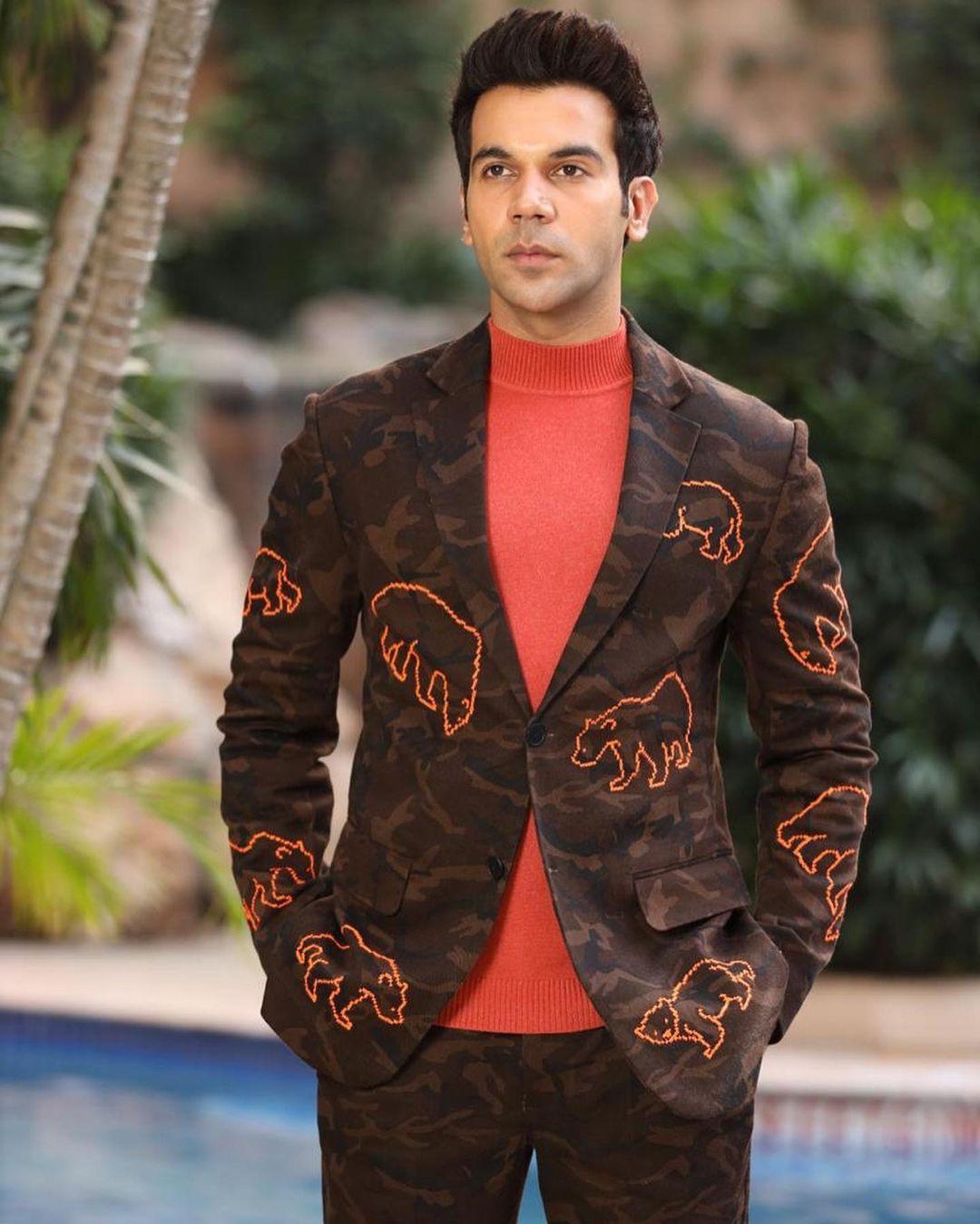 Rajkummar Rao exudes an effortless cool in a casual ensemble comprising a camouflague blazer and pants, with the blazer sporting an unexpected twist of animal print.