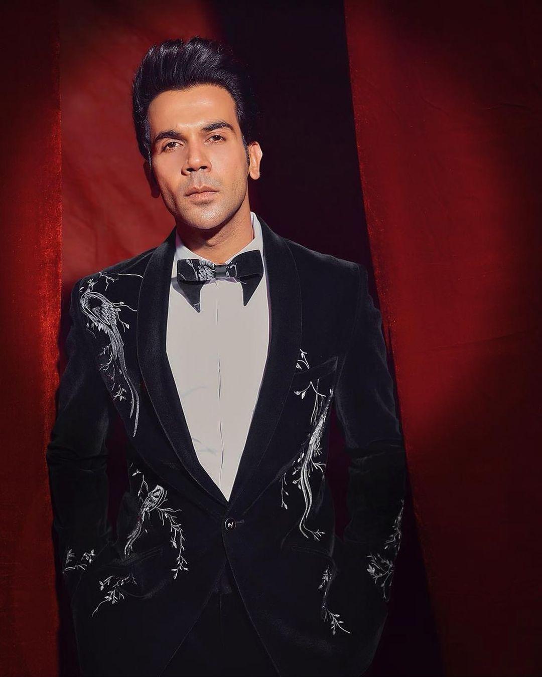 Rajkummar Rao emanates timeless sophistication in a black tuxedo adorned with intricate white patterns. The white detailing adds a touch of elegance to the classic ensemble, reflecting his ability to effortlessly fuse tradition with a hint of contemporary flair.