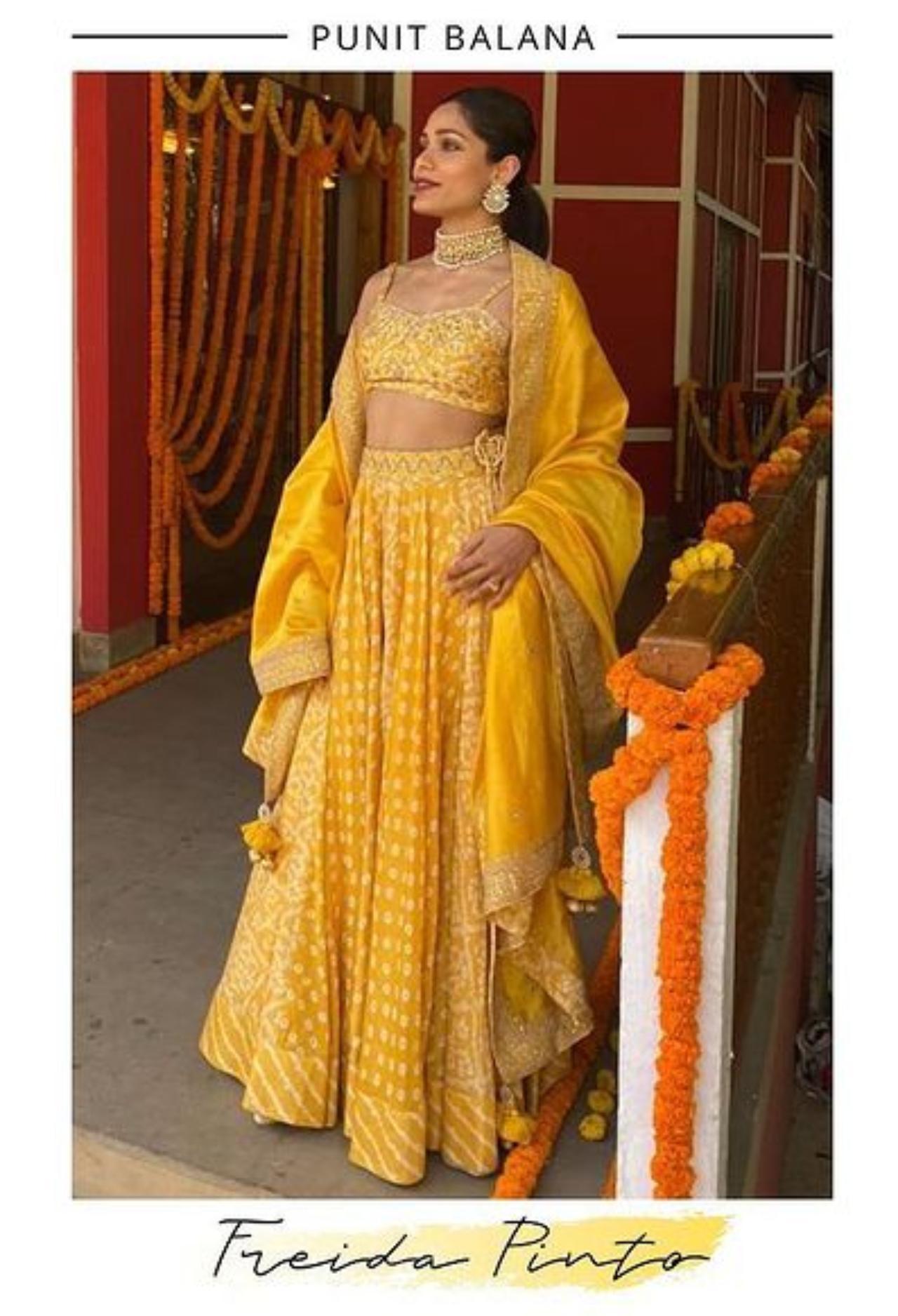 Freida Pinto
Diwali came early this year with this vibrant outfit! Freida Pinto chose a radiant sunshine yellow lehenga designed by Punit Balana, which included a sleeveless blouse paired with a sheer skirt