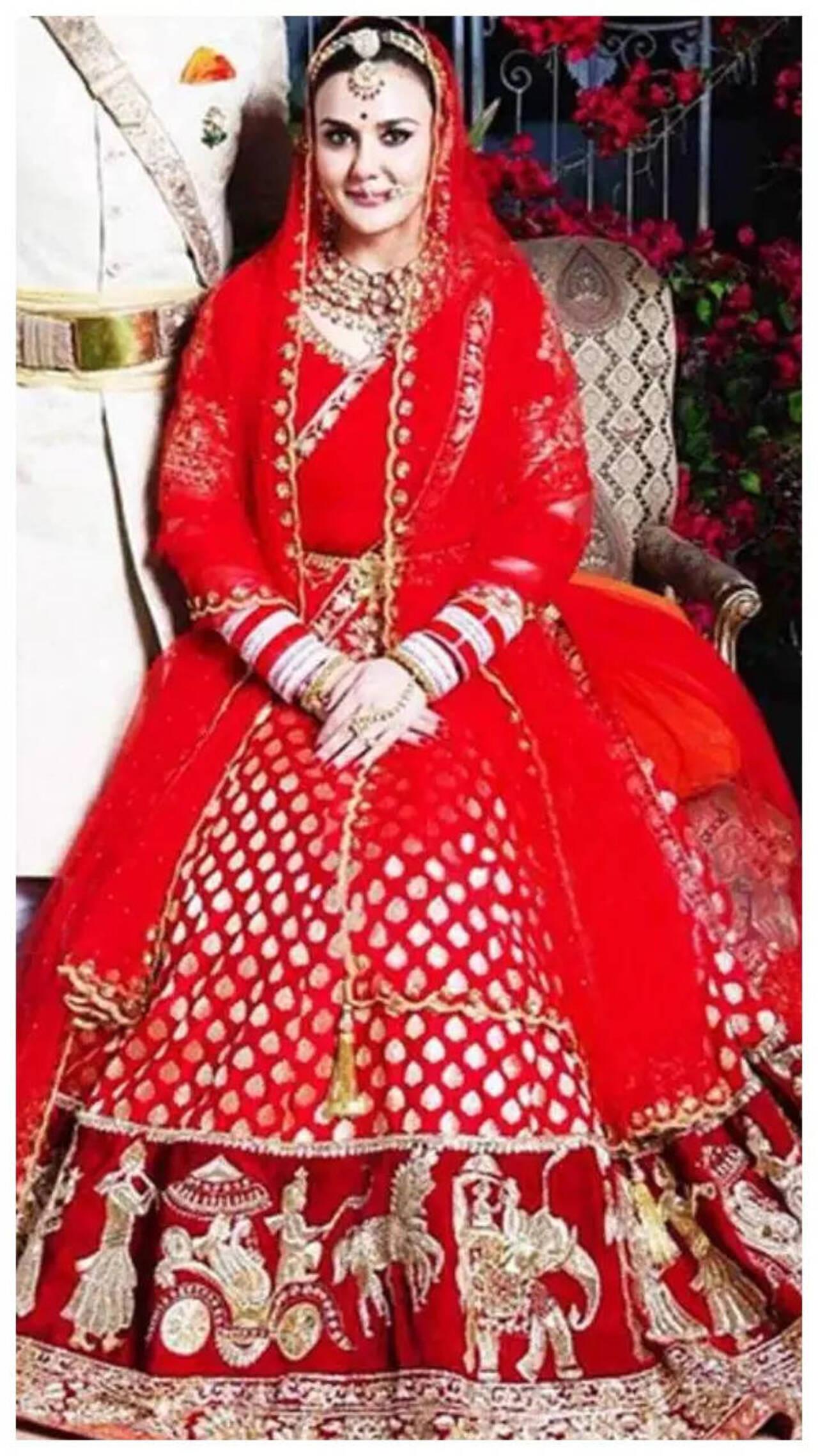 Preita Zinta
Bollywood actresses have been vying for Mnaish Malhotra's bridal couture since yore! Preity Zinta chose a heavy lehenga in deep hues of crimson and gold for her wedding. Her multilayered necklace and thick complementing red-gold chooda accentuated the bride's glow on her special day