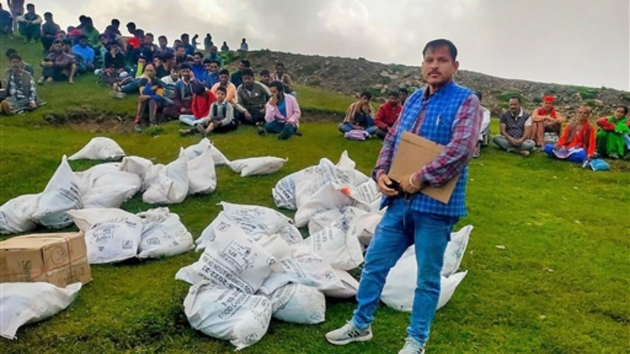 Relief materials, that were supplied by an IAF helicopter, are kept to be distributed to the flood-affected people, in Mandi