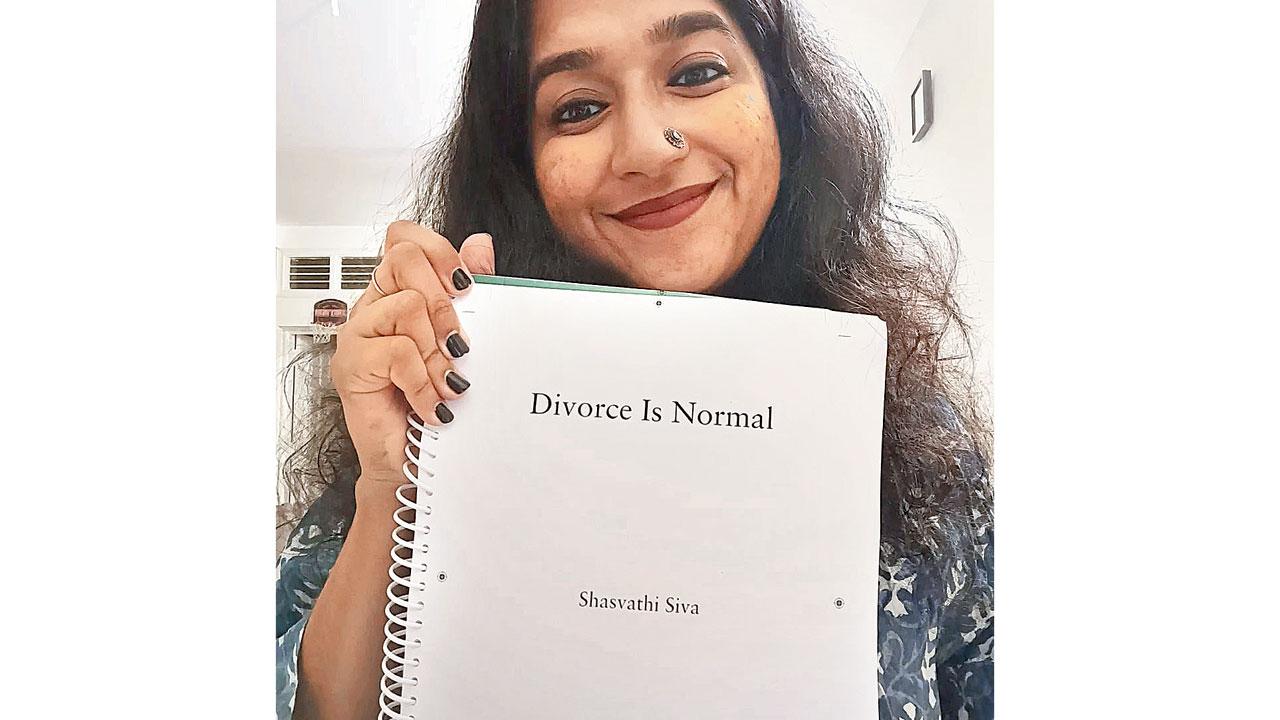 Shasvathi Siva poses with the first draft of her book