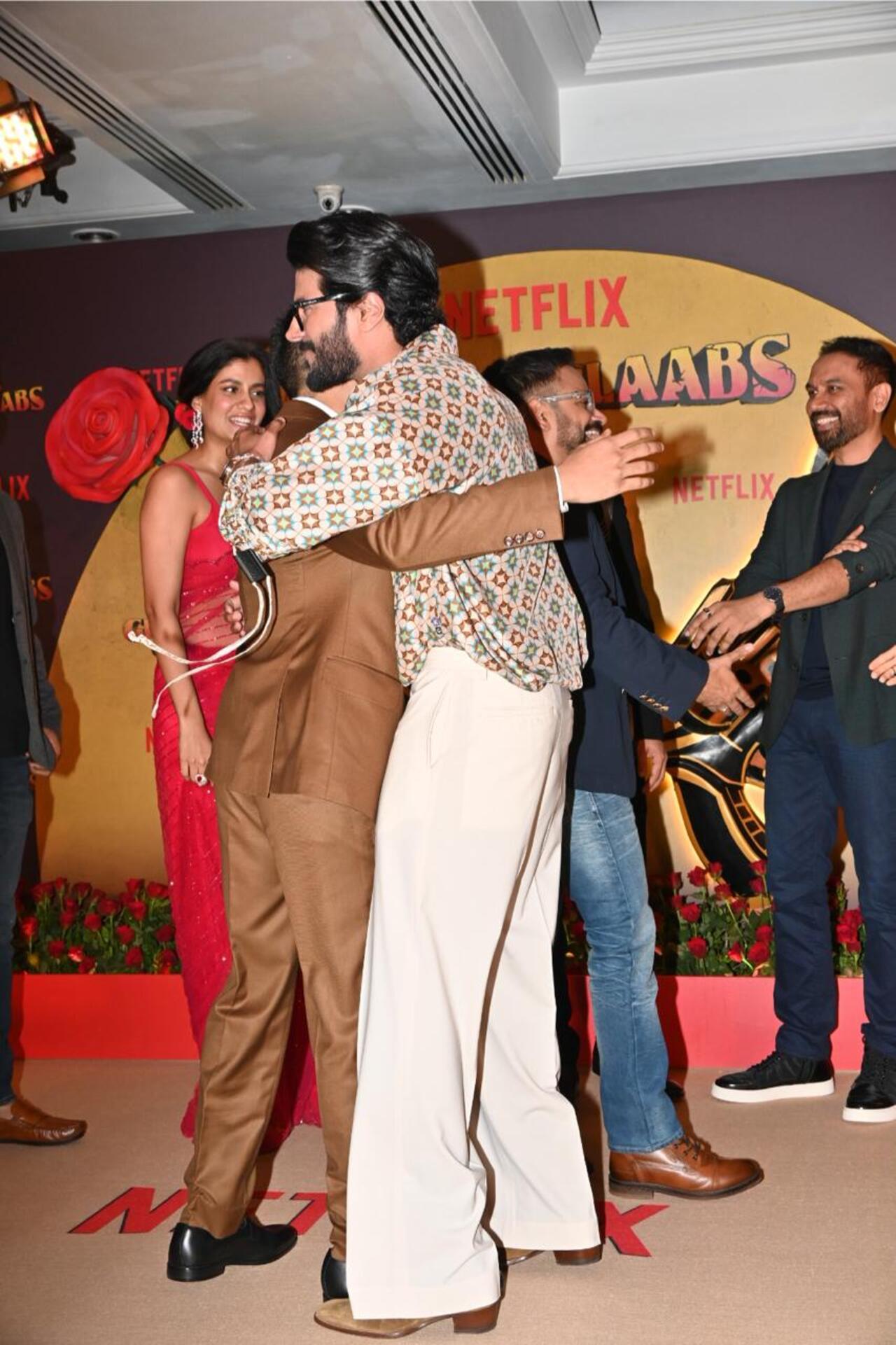 Dulquer Salmaan gives a hug to co-star Adarsh as he arrives for the screening