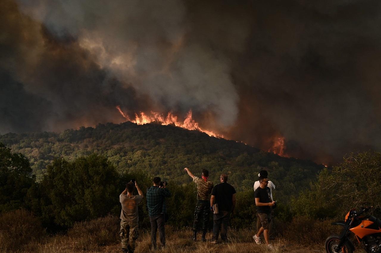 Greece's largest active forest fire was burning out of control for the fifth day near the city of Alexandroupolis in the country's northeast, while authorities were trying to prevent a blaze on the northwestern fringe of Athens from scorching homes and reaching the Parnitha national park, one of the last green areas near the Greek capital