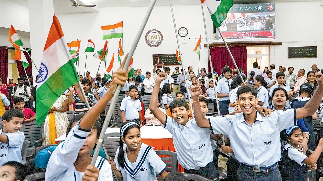 Students celebrate after the successful soft landing of ‘Chandrayan-3’ on the Moon’s surface, in Lucknow, on Wednesday