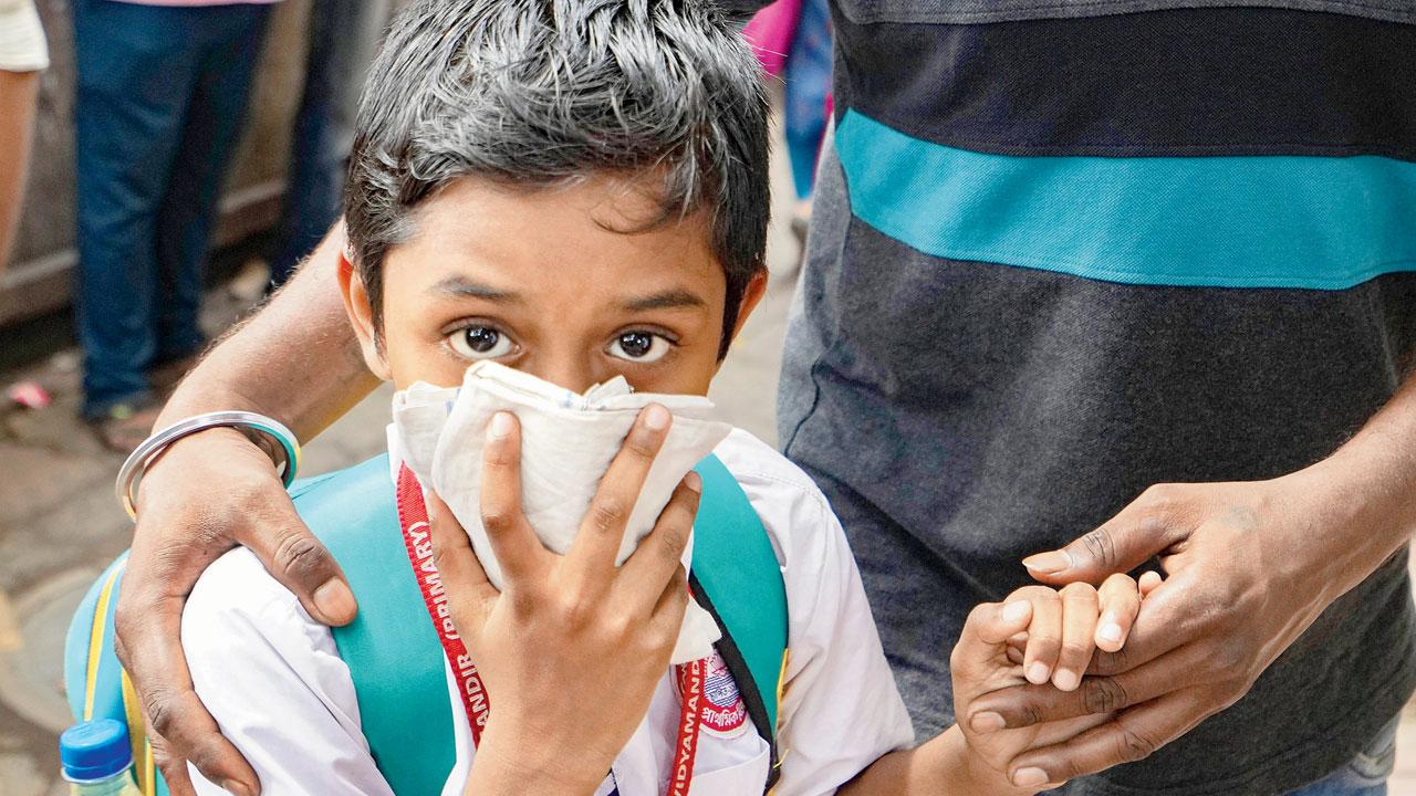 A school student covers his face to protect himself from the tear gas