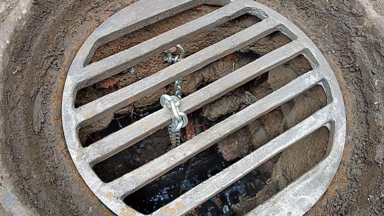 A grill secured by a chain, which helps prevent accidents if manhole covers are stolen