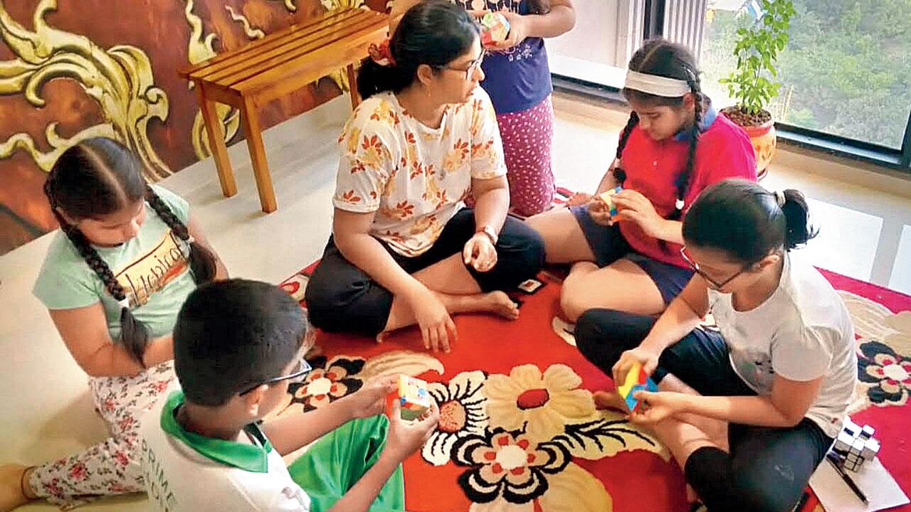 Minella Gracious teaches children how to solve the cube