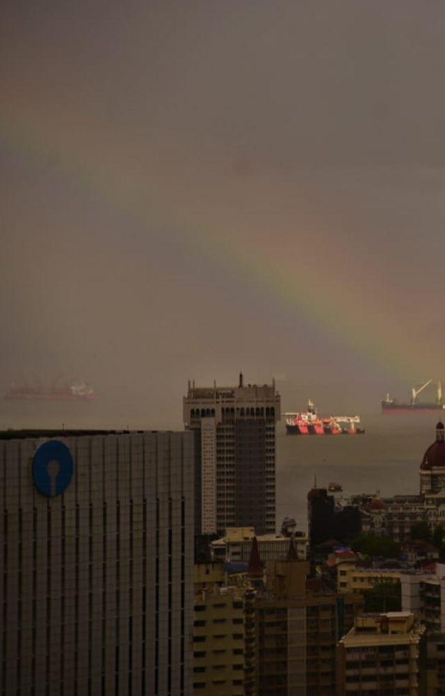 Against the clouds and expanse of tall buildings of the city, shimmered the rainbow atop Mumbai`s skyline