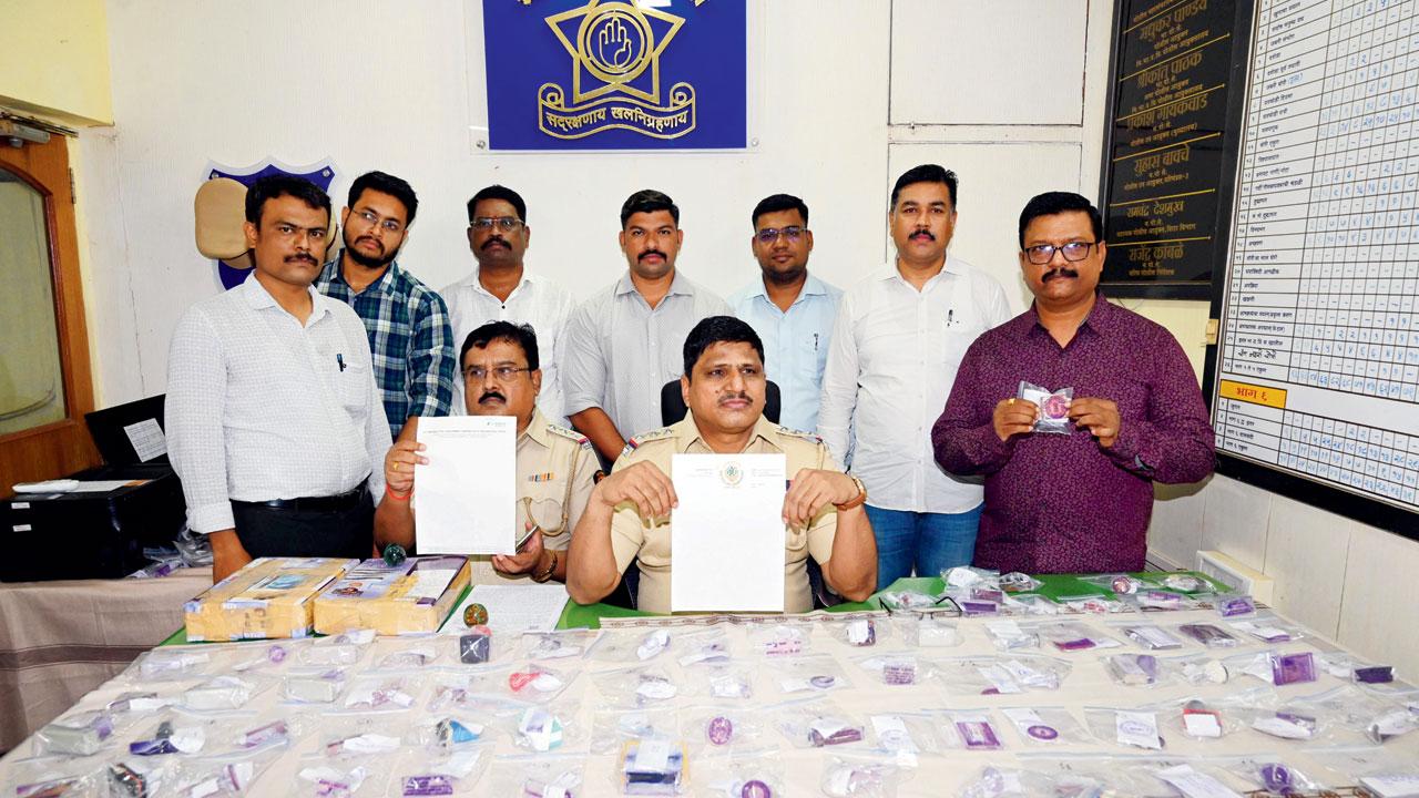 A police team with the seized fake stamps, and other documents, etc