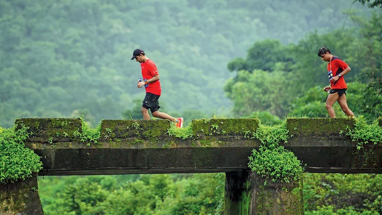 Runners cross a bridge over Amba river in Durshet during a previous marathon