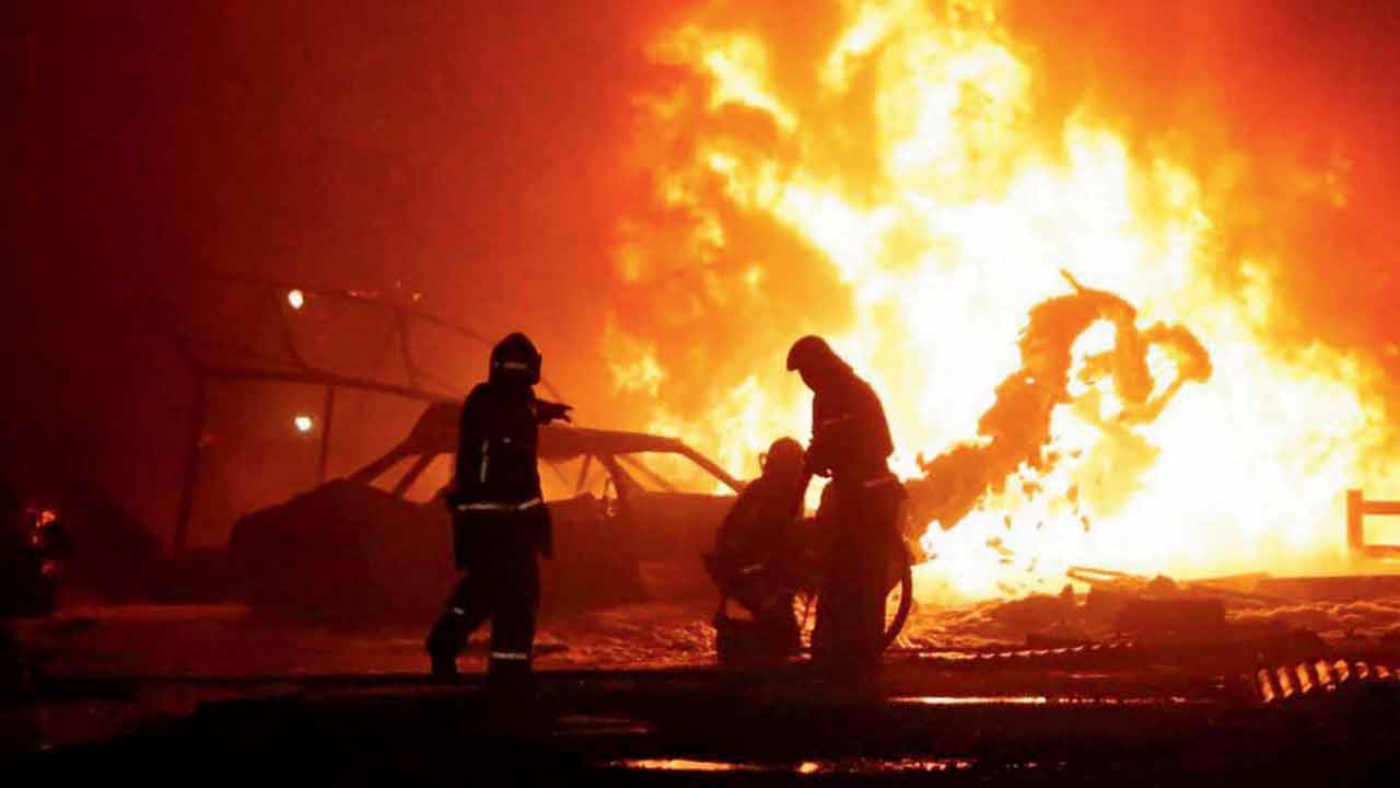 Rescuers battling the blaze at the gas station. Pic/AP