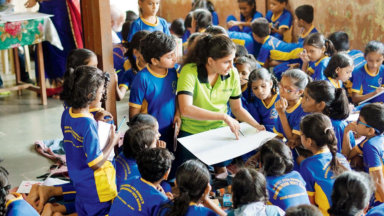 A volunteer interacts with children