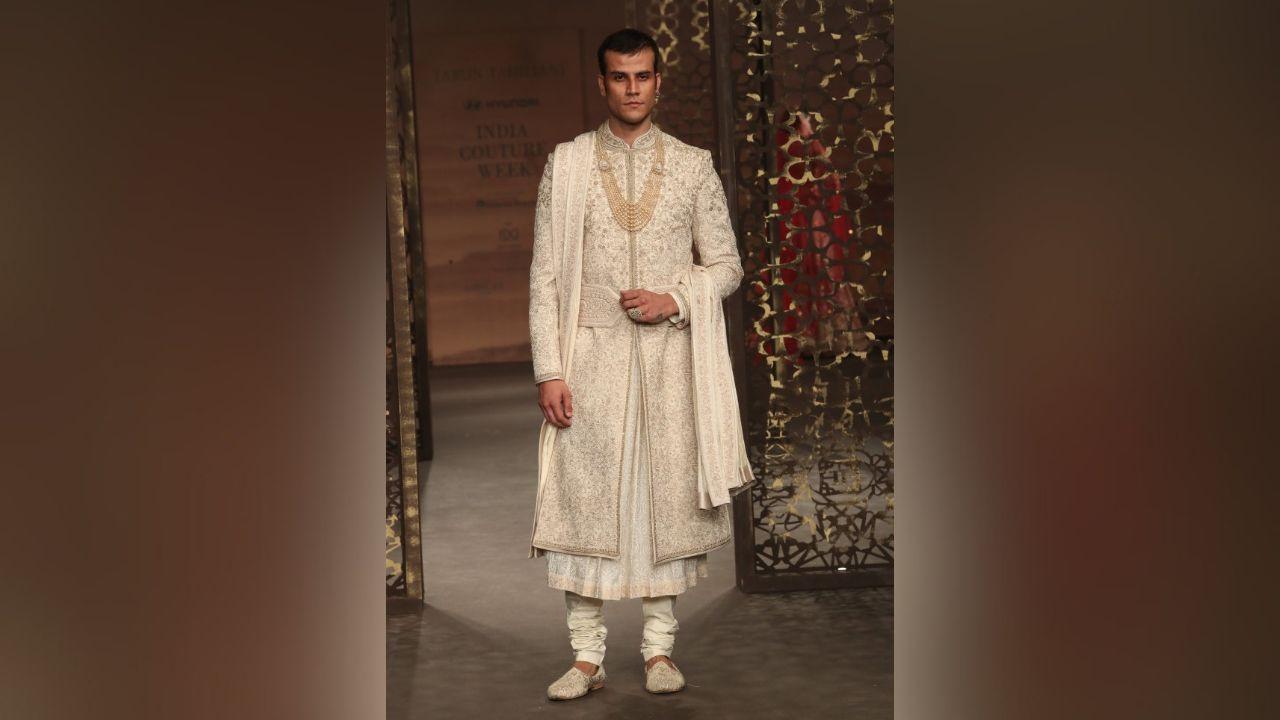 Embracing draped silhouettes, dhotis take center stage as the epitome of cool, while kurtas are reimagined for a sense of ease and effortless style. The collection features structured fits, buttoned shirts, cummerbunds reimagined as belts, plunging cowl necklines, and open jackets, replacing conventional styles with a fusion of masculine flair, innovative tailoring, and sartorial drama.