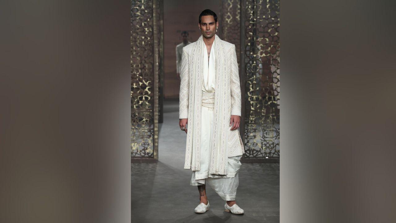 With Bespoke Couture in womenswear, each couture creation initiates a brave dialogue between the voice of tradition and the wearer, where lightness finds its home in pure georgettes, silks, organzas, tulles, and brocades. The canvas becomes a playground for fusion-inspired silhouettes, ranging from lehengas and heavily embellished shararas to stylish gilets, statement jackets, flowy concept saris, structured drapes, and fusion-style jumpsuits.