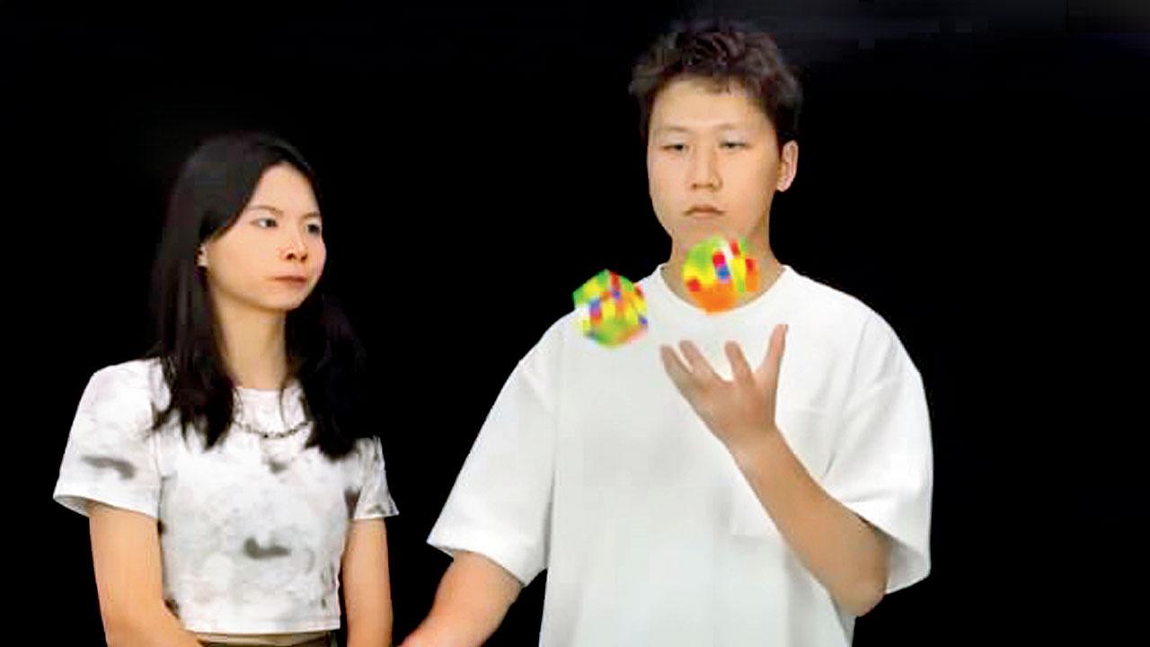 Zhihao Li (right) broke his own record of solving three cubes while juggling them in three minutes 16 seconds, 13 seconds faster than the previous record. Pic courtesy/YouTube