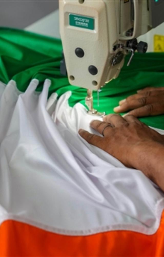 In Mumbai, a worker stitches an Indian national flag ahead of Independence day celebrations