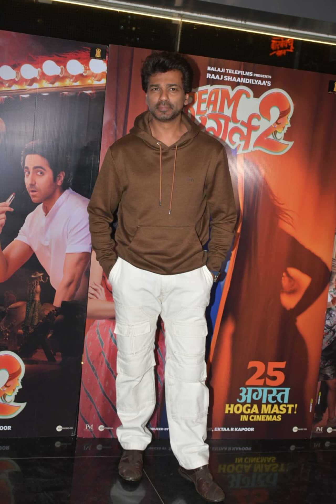 Nikhil Dwivedi attend the screening in a brown hoodie and white pants