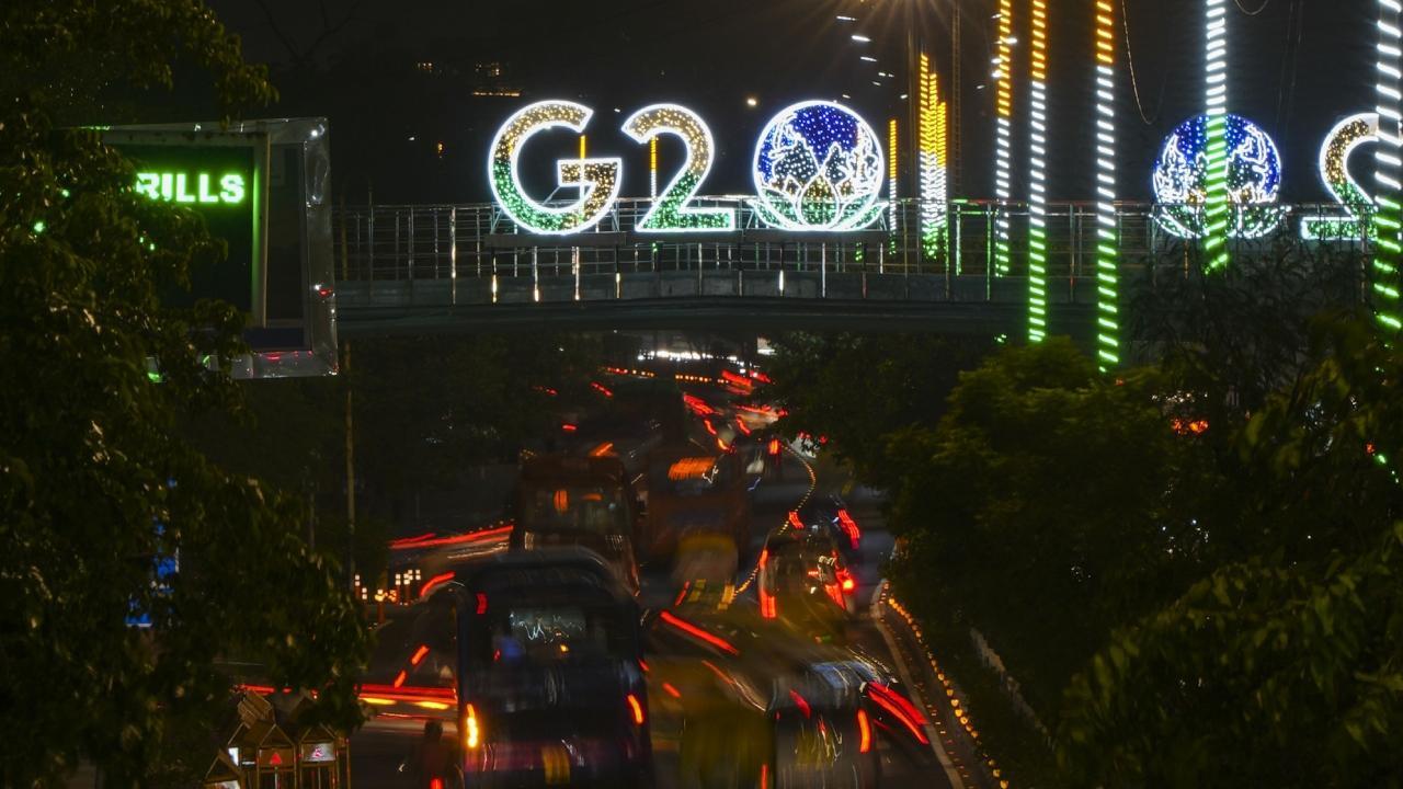 Vehicles move past an illuminated logo of G20 ahead of the summit in New Delhi. Pics/PTI