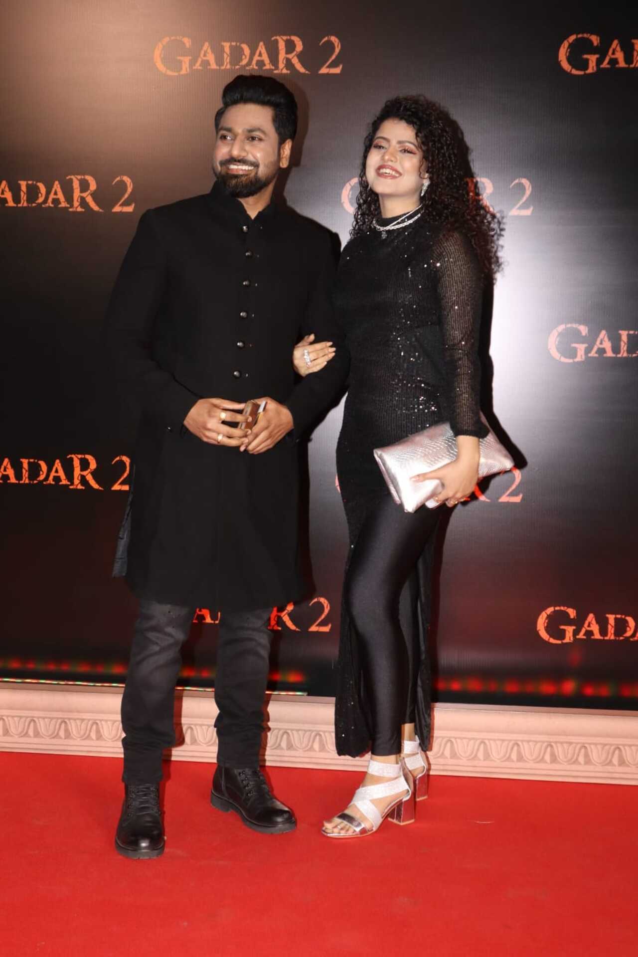 Palak Mucchal and Mithoon pose together in black at the screening