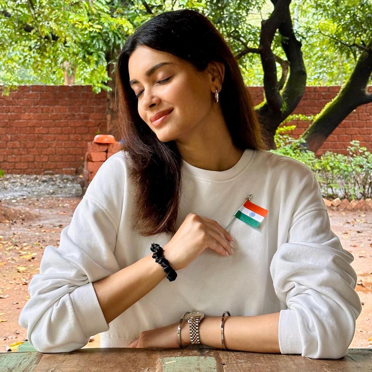 Diana Penty marks the day holding a flag badge close to her heart
