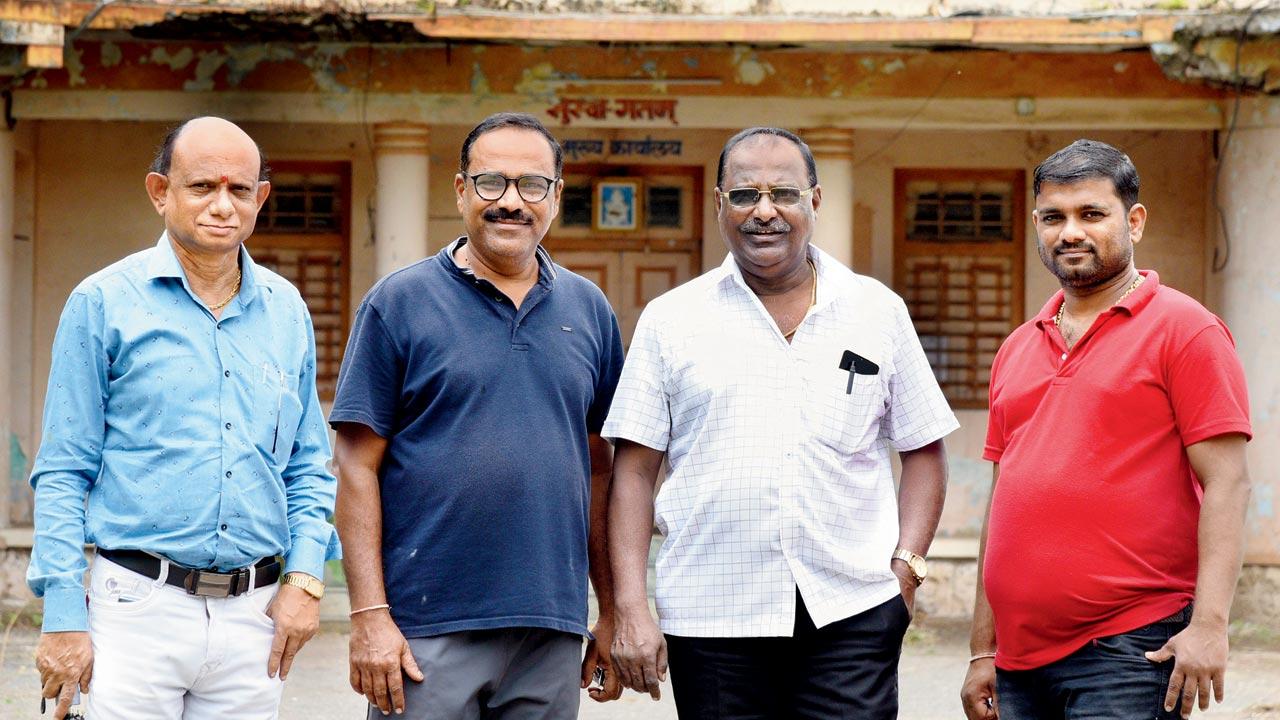 Chandrakant Tare (in white), chairman of Satpati Fishermen Sarvoday Sahakari Society Ltd, along with the ex-chairman Sanjay Tare and other members outside the old building of the society