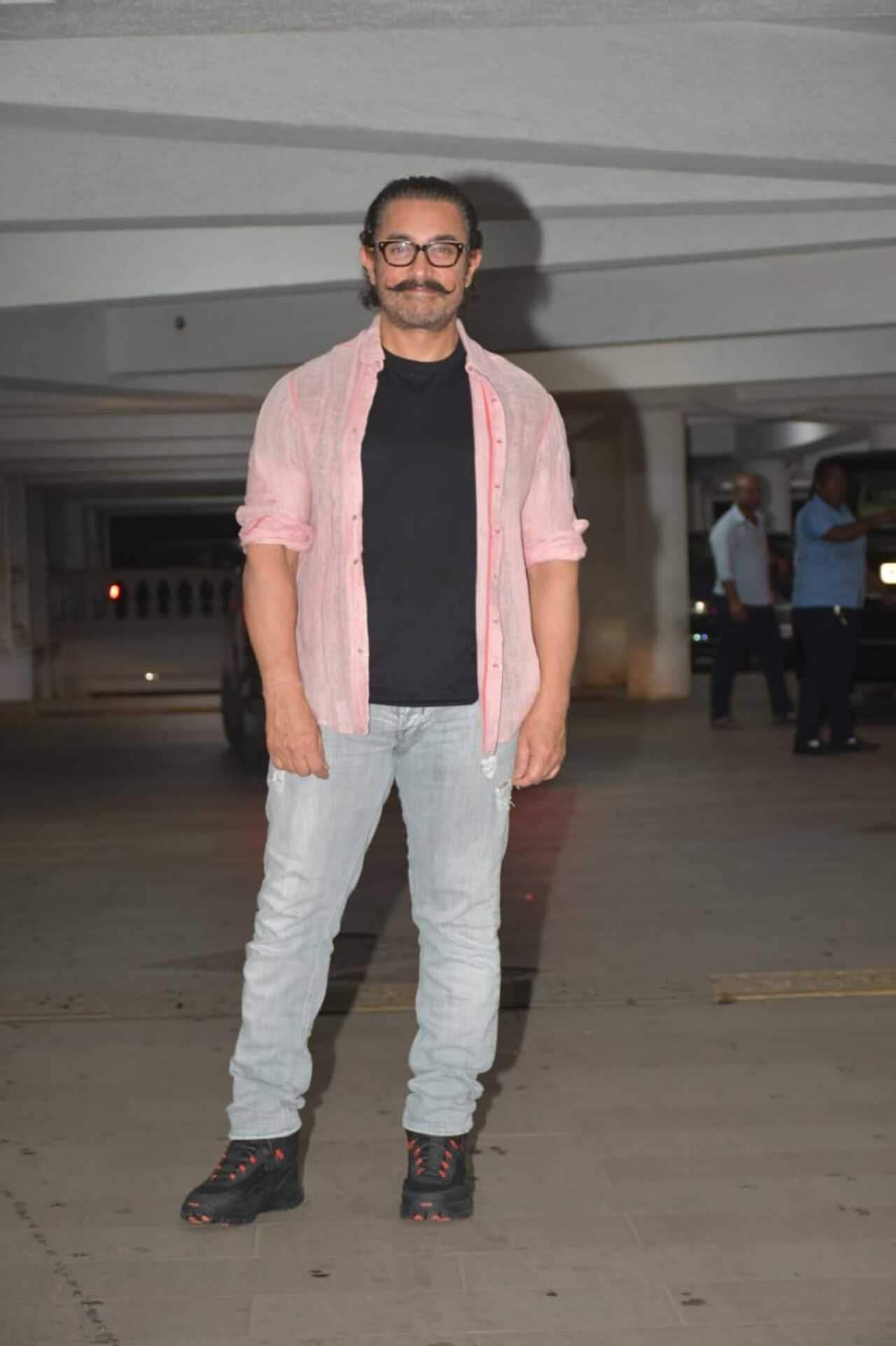 Aamir Khan kept it simple in a pink shirt, black t-shirt and denims for the party