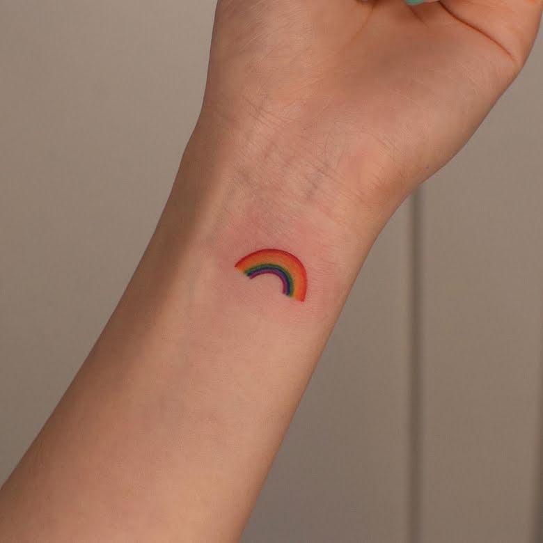 She also has the prettiest rainbow inked is prismatic hues on the inner side of her wrist