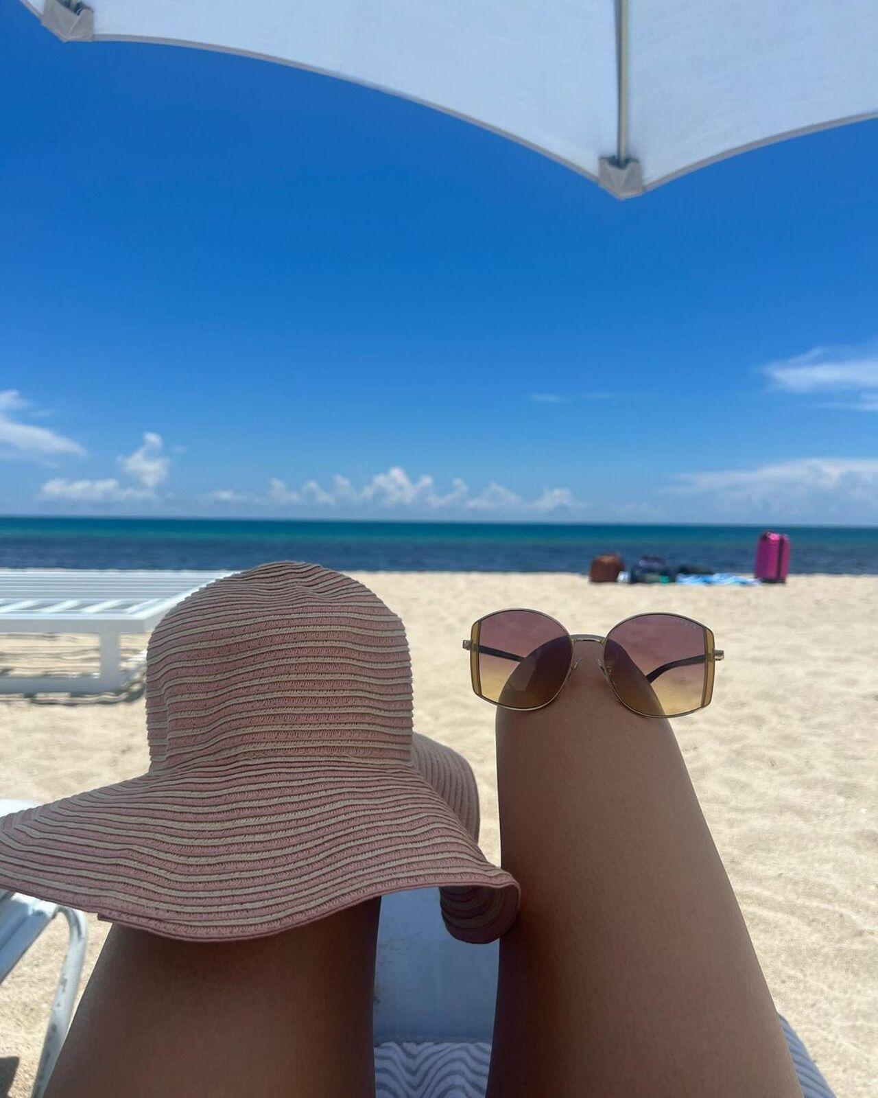 A cap, sunglasses and the beach view, make for the perfect beach essential