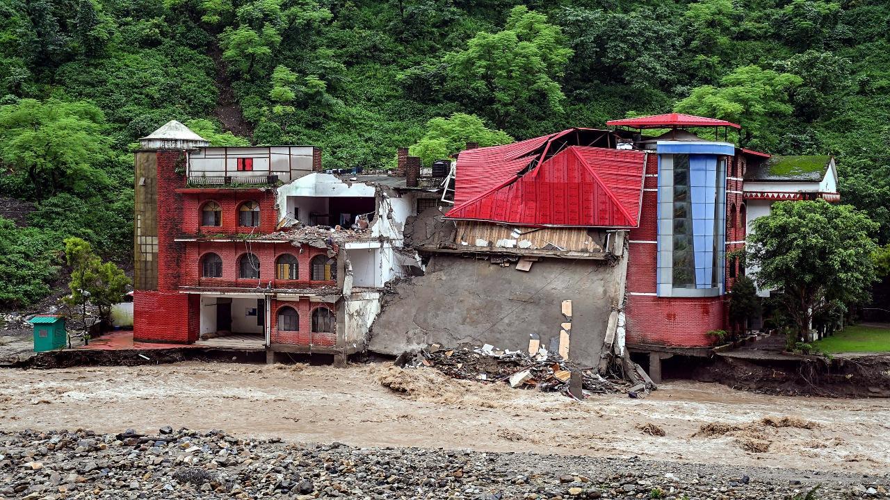 Torrential rains ravaged Uttarakhand on Monday, destroying buildings and causing landslides which breached the national highways to Badrinath, Kedarnath and Gangotri shrines and left three people dead and five others missing. Photos/PTI