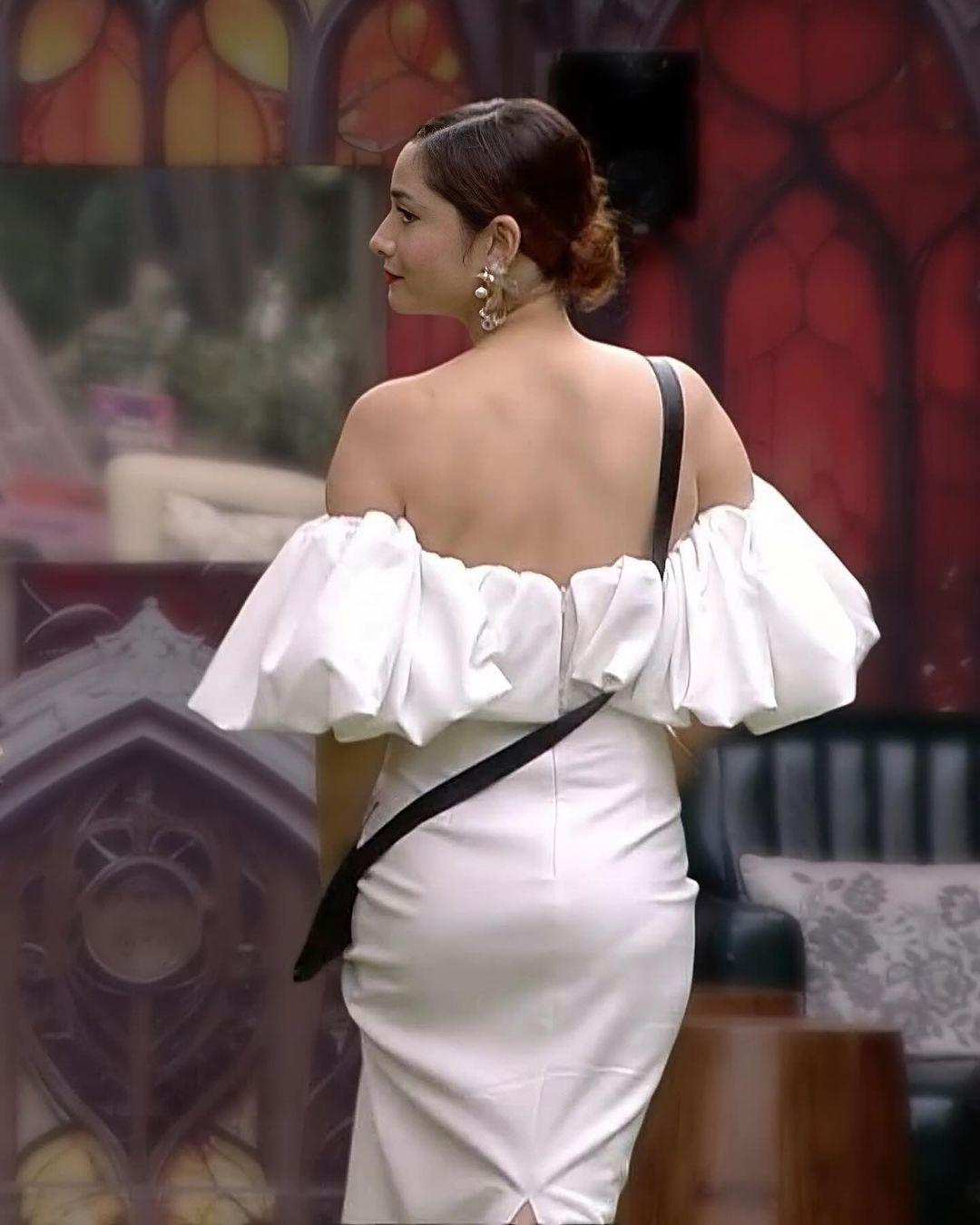 In one of the episodes of Bigg Boss 17, Ankita Lokhande wore a stunning off-shoulder white dress. She tied her hair in a chic bun, and the contrasting bold red lipstick stole the show