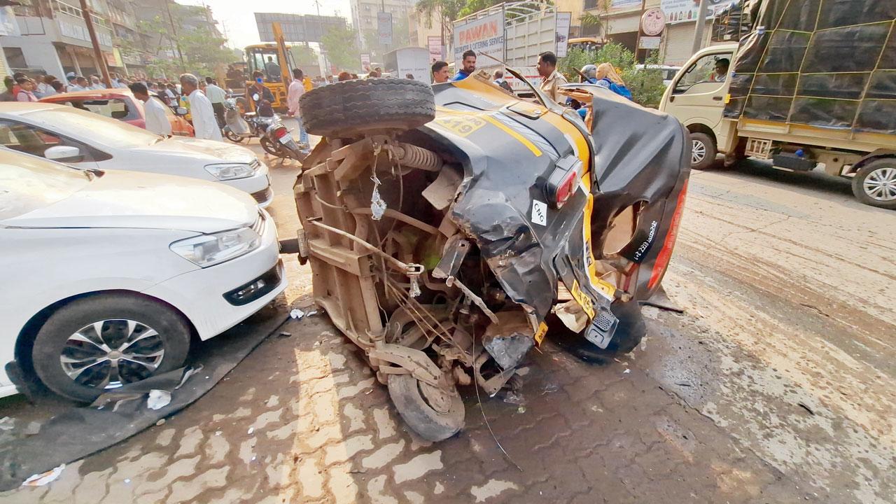 The mangled remains of the auto-rickshaw carrying the three victims