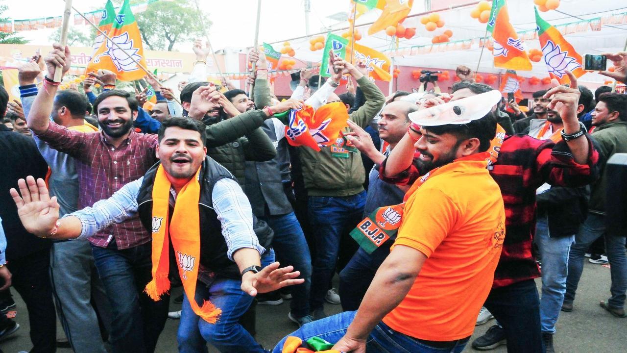 Bharatiya Janata Party (BJP) workers celebrate as the party leads in the Rajasthan Assembly elections, at the party office, in Jaipur on Sunday. BJP crossed the halfway mark, which is 100 out of the 199 seats in the Rajasthan Assembly. ANI Photo