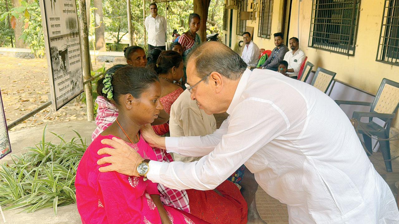 Tribal leader Vivek Pandit with the bonded labourers and their children