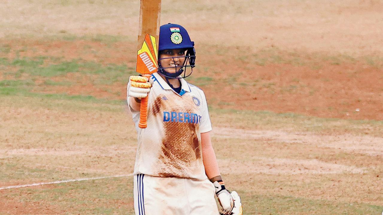 India’s Deepti Sharma celebrates her half-century against Australia at the Wankhede Stadium yesterday