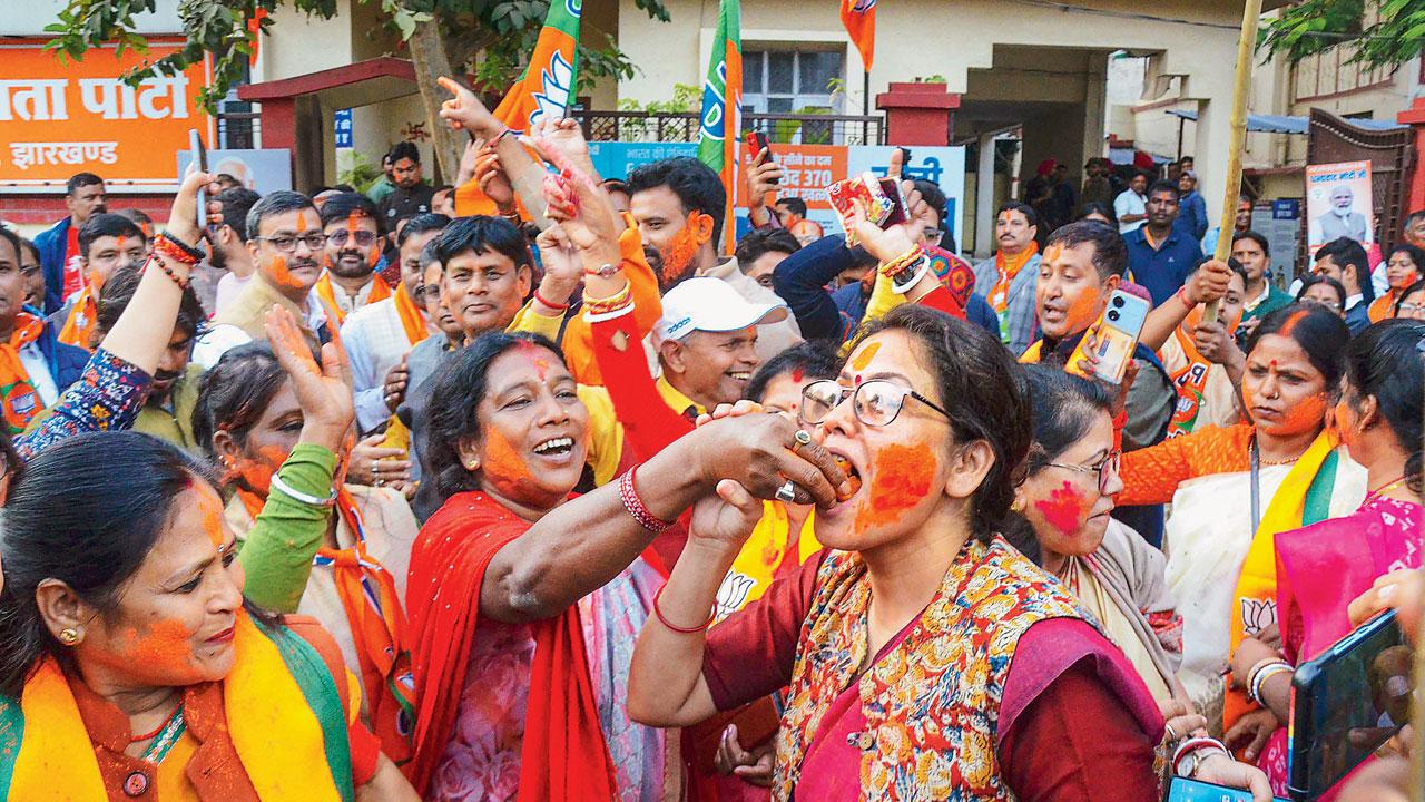 BJP workers celebrate the party’s win at the party headquarters, in New Delhi. Pic/PTI