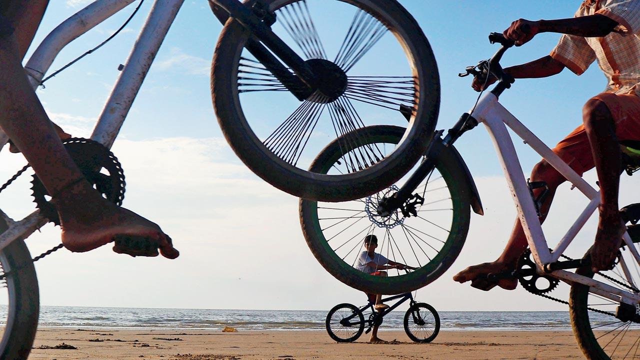 Boys practise stunts on their bicycles at Aksa beach, Malad West. Pic/Anurag Ahire