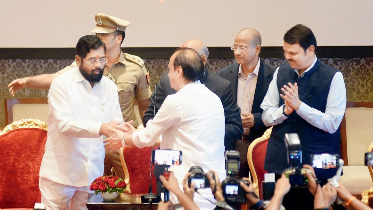 Ajit Pawar is welcomed by Chief Minister Eknath Shinde just before he takes oath as deputy CM of Maharashtra.  All three were contenders for the CM’s post. Pic/Sameer Markande