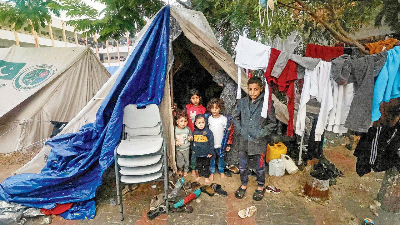 Displaced children stand near their makeshift tent. PIC/AP