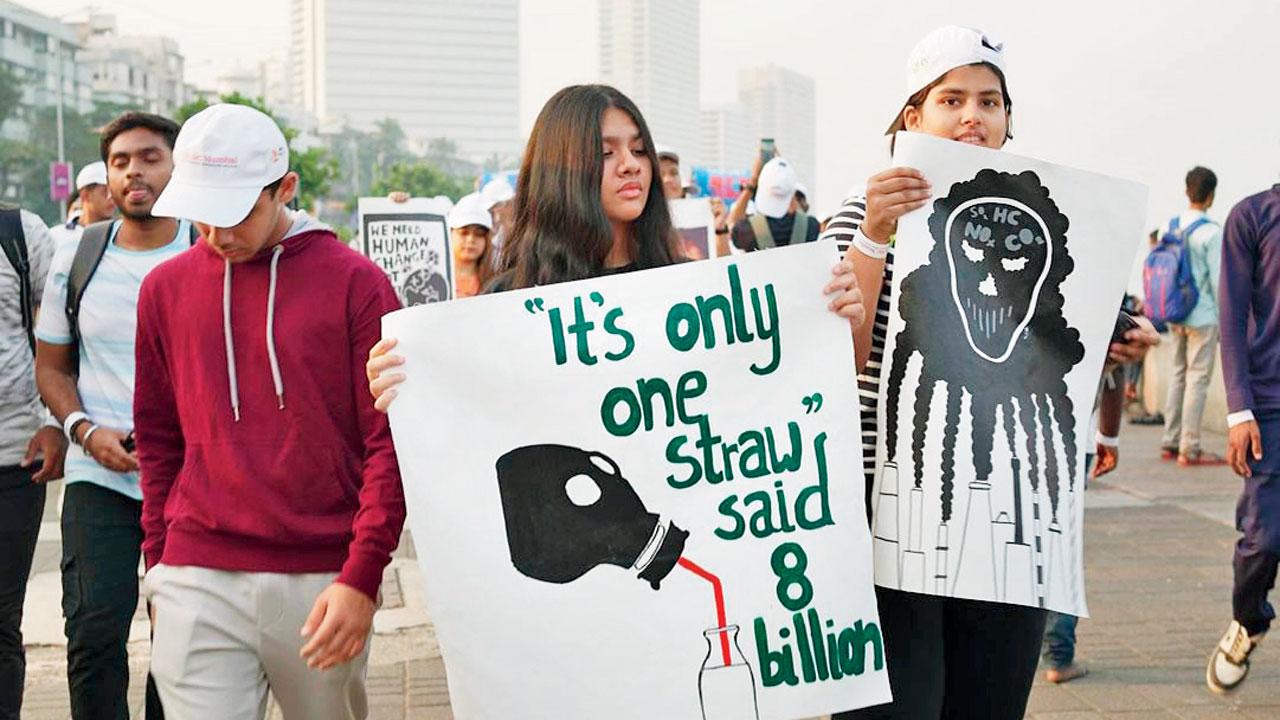 Young participants display posters during the walk