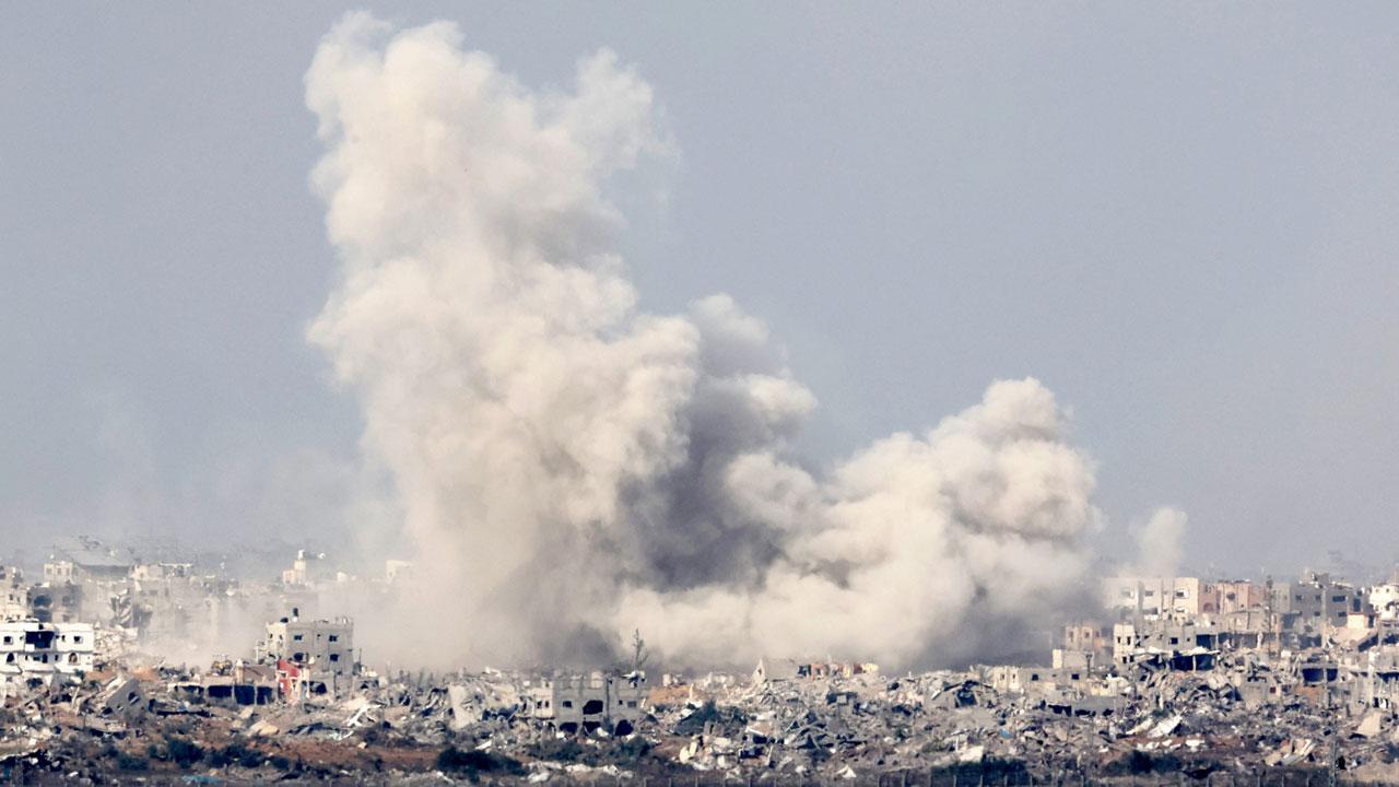 Smoke rises above buildings during an Israeli strike in northern Gaza on Friday. Pics/AFP