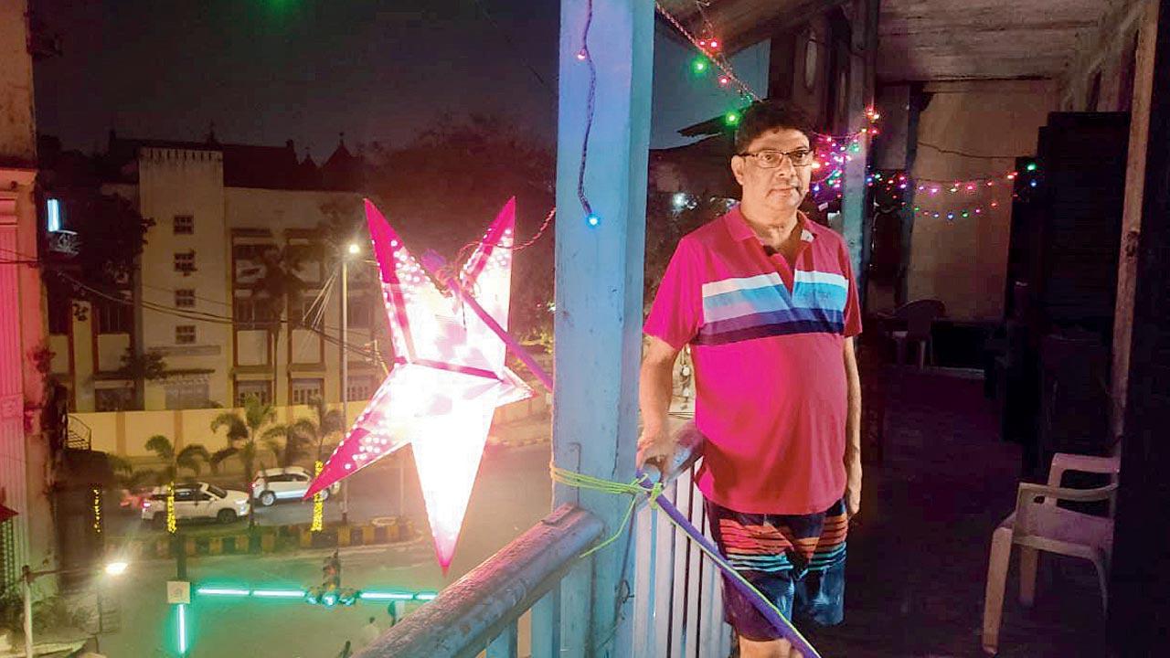 A resident of Jer Mahal’s Majorda kudd stands at a balcony lit up for Christmas 2023. Pic Courtesy/Aida Dourado