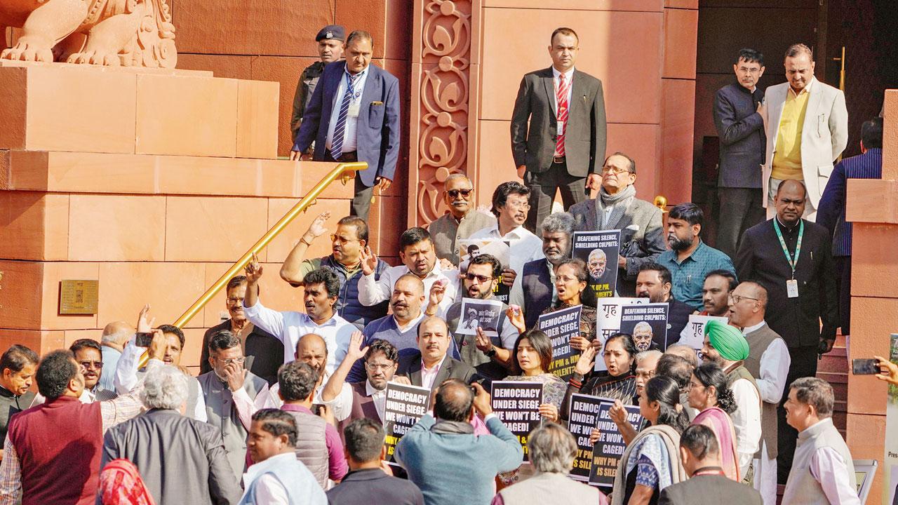 Suspended Oppn MPs protest during the Winter session. Pic/PTI