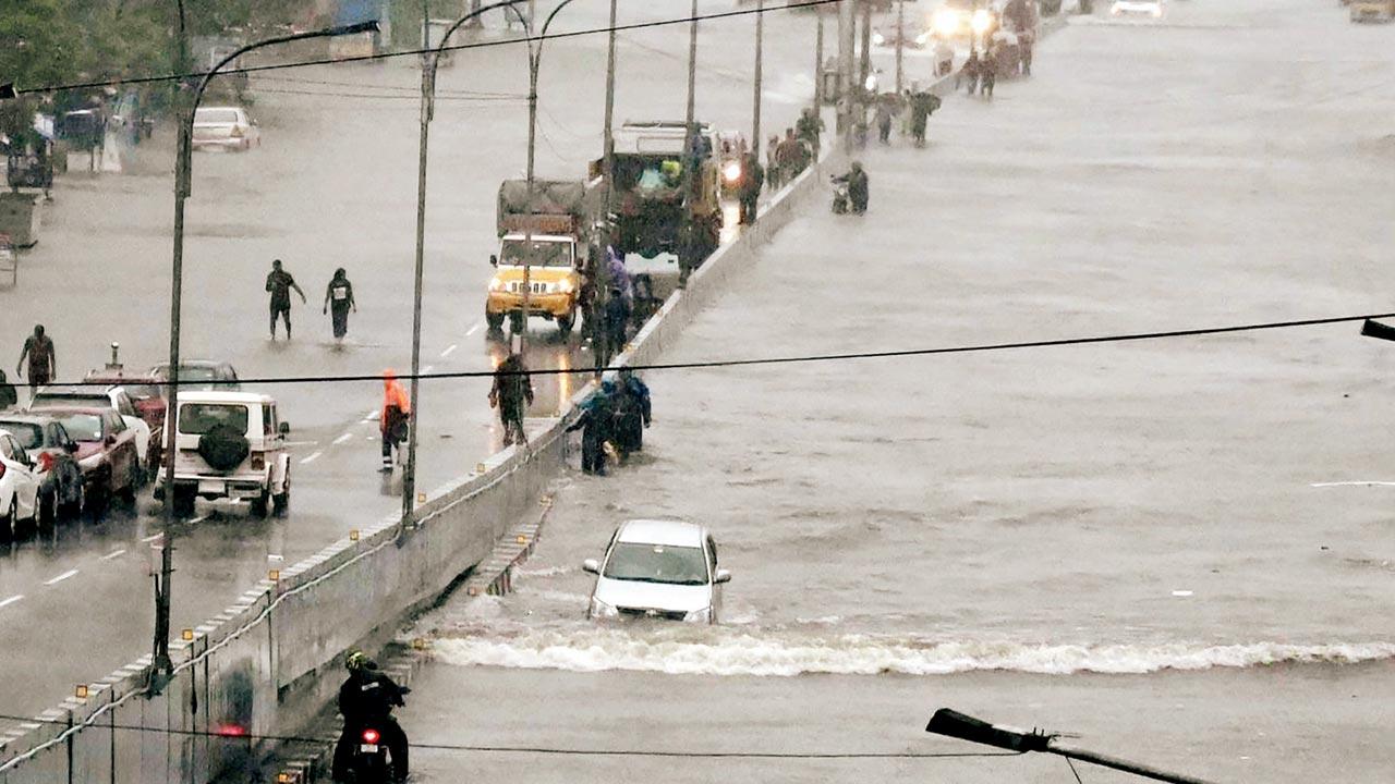 People wade through a flooded road